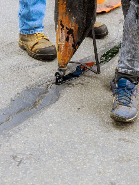 driveway-repair-along-asphalt-crack-1.jpg